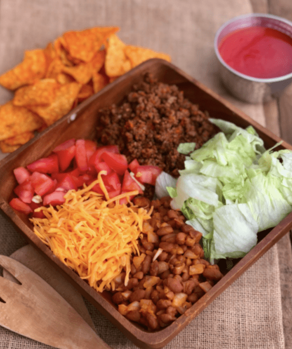 Taco salad with lettuce, cheese, and beans.